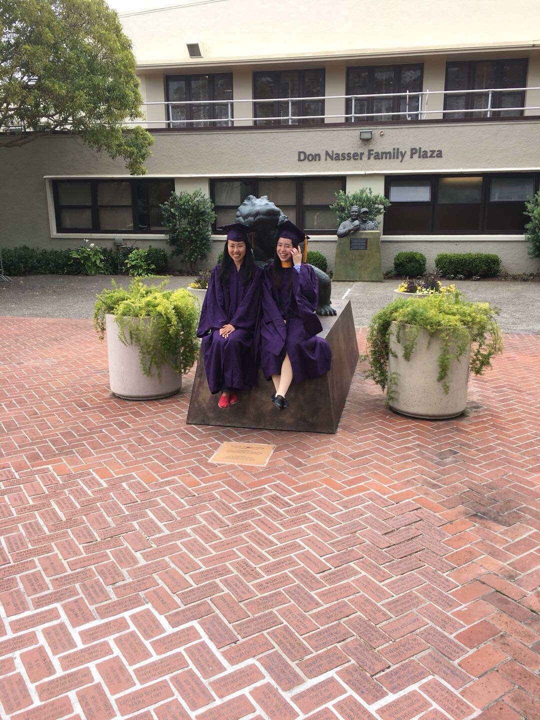 Lijie Zhou and a fellow graduate at the Don Nasser Family Plaza on the SFSU campus